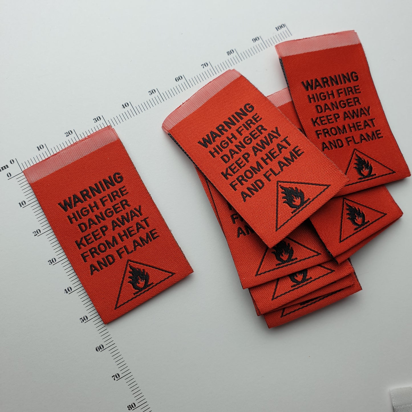 WARNING - HIGH FIRE DANGER - KEEP AWAY FROM HEAT AND FLAME - WOVEN LABELS