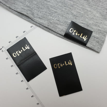 #08BS - SEMI-PERMANENT SINGLE COLOUR PRINTED BLACK SATIN HOT CUT HEM LABELS